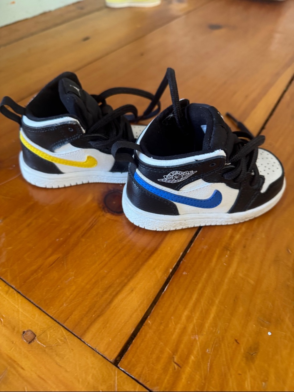 Nike Black and White Jordan 1 Sneakers with Blue, Red, Green and Yellow Swooshes